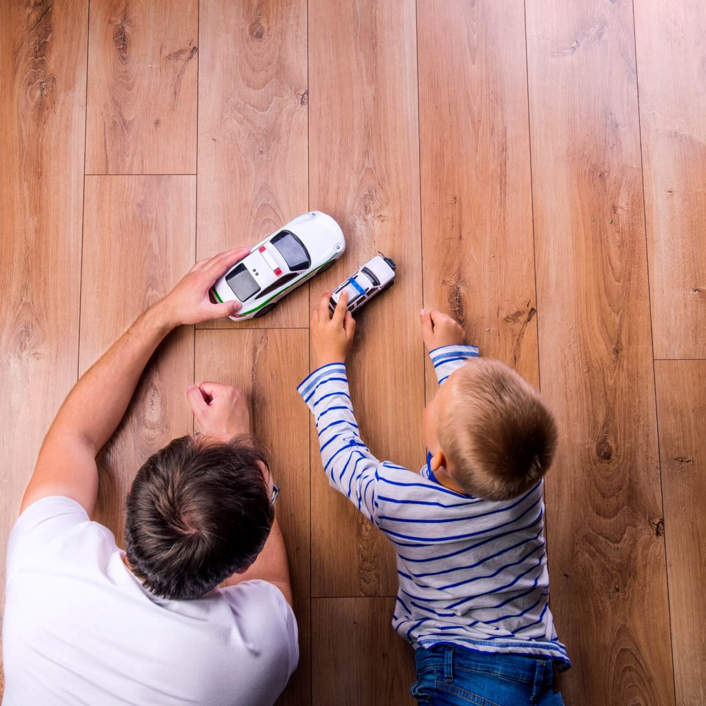 Father and kid playing with toycar | Shoreline Flooring