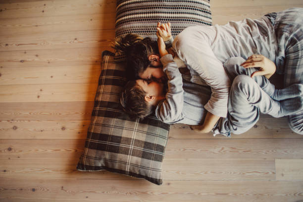 Loving mom tickling her kid on flooring | Shoreline Flooring