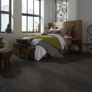 Dark hardwood in a modern bedroom with a large bed | Shoreline Flooring